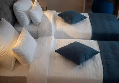 two beds with pillows on them in a bedroom at Hotel Idila Budva in Budva