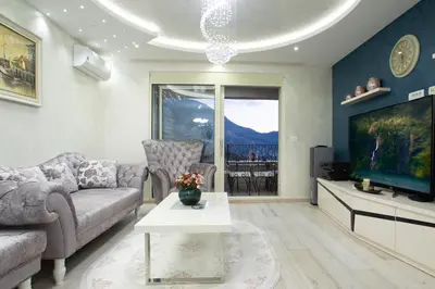 a living room with a couch and a tv at Apartment Boka View in Kotor