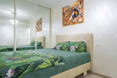 a bedroom with a bed and a mirror at Apartment Boka View in Kotor