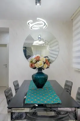 a vase with flowers on a table in a room at Apartment Boka View in Kotor