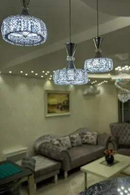 a living room with a couch and chandeliers at Apartment Boka View in Kotor