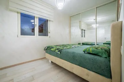 a bedroom with a large bed and a window at Apartment Boka View in Kotor