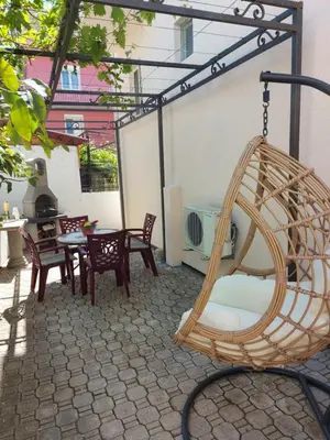a patio with chairs and a swing at Villa Lyudmila in Utjeha
