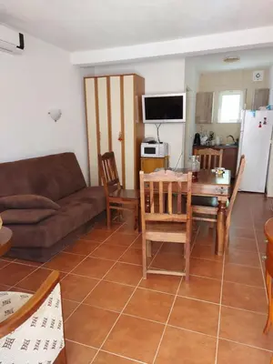 a living room with a couch and a table at Villa Lyudmila in Utjeha
