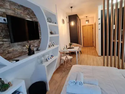 a room with a bed and a television on a wall at Apartment Juliette Budva in Budva
