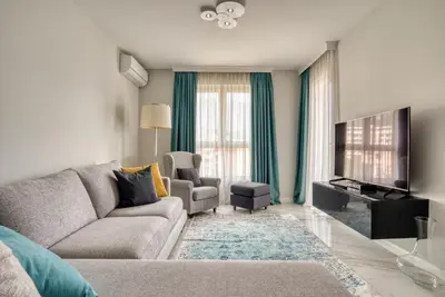 a living room with a couch and a tv at Apt 