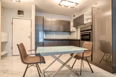 a kitchen with a table and chairs in a room at Apt 