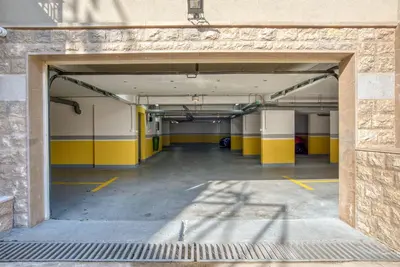 an empty parking garage with yellow and white walls at Apt 