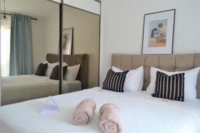 a bedroom with two beds and a mirror at Villa Gabriela in Kotor