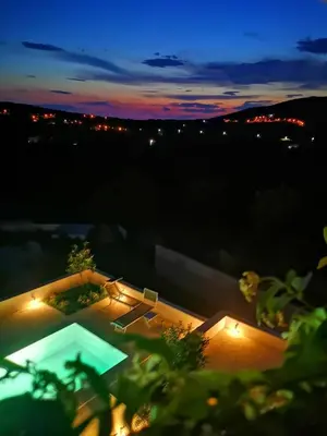 a view of a swimming pool at night at Villa Gabriela in Kotor
