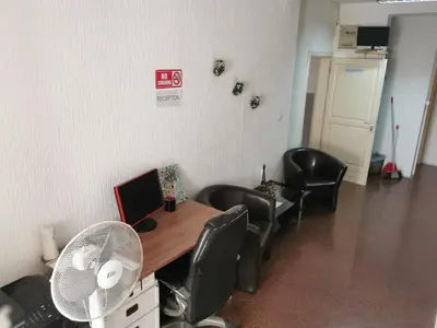 an office with a desk with chairs and a fan at Stars Aspava Blue HOSTEL in Podgorica