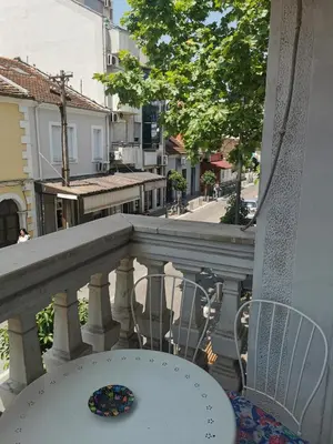 a balcony with a table and chairs and a street at Stars Aspava Blue HOSTEL in Podgorica