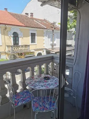 a table and chairs on a balcony with a view at Stars Aspava Blue HOSTEL in Podgorica