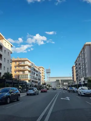 a city street with cars parked on the road at Sunny City - City Kvart in Podgorica