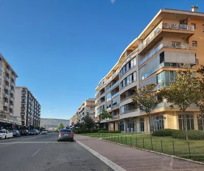 a car parked on a street next to a building at Sunny City - City Kvart in Podgorica