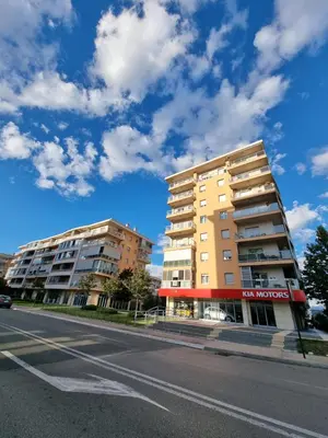 two tall buildings on the side of a street at Sunny City - City Kvart in Podgorica
