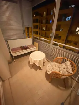a balcony with a table and a chair and a bench at Sunny City - City Kvart in Podgorica