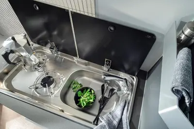a kitchen sink with a bowl of greens in it at Camper Montenegro and Recreational Vehicles in Budva