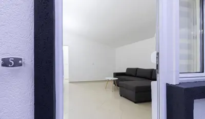 a door to a living room with a couch at Apart-Hotel Prestige in Ulcinj
