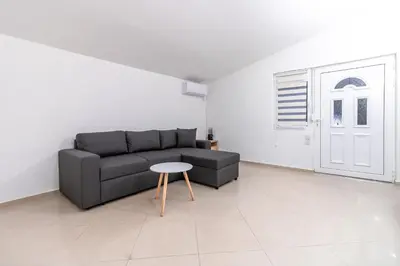 a living room with a couch and a table at Apart-Hotel Prestige in Ulcinj