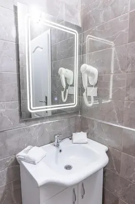a bathroom with a white sink and a mirror at Apart-Hotel Prestige in Ulcinj