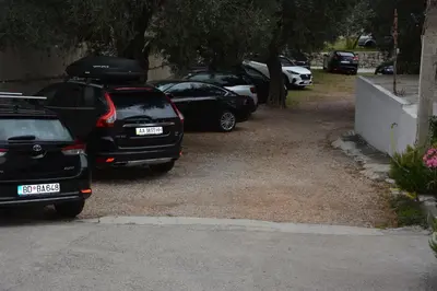 a group of parked cars parked in a driveway at Apartments Djedovic 2 in Petrovac na Moru