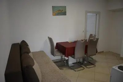 a dining room with a red table and chairs at Apartments Djedovic 2 in Petrovac na Moru