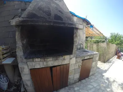 an outdoor brick oven in a yard at Apartments Djedovic 2 in Petrovac na Moru
