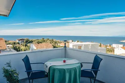 a table and chairs on a balcony with a view of the ocean at Seaview Apartments Bonaca in Bar