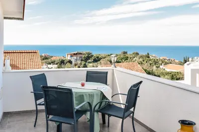 a table and chairs on a balcony with a view of the ocean at Seaview Apartments Bonaca in Bar