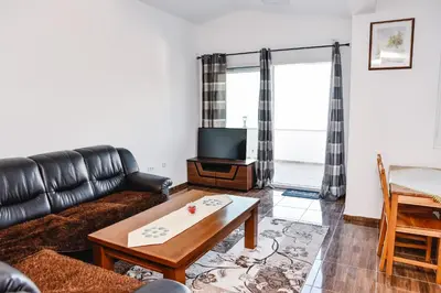 a living room with a couch and a tv at Seaview Apartments Bonaca in Bar