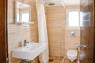 a bathroom with a sink and a toilet at Seaview Apartments Bonaca in Bar