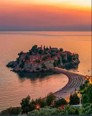 an island in the water with a town on it at Horizon Two bedroom Penthouse with Hot tub in Becici