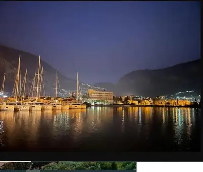 a group of boats docked in a harbor at night at Horizon Two bedroom Penthouse with Hot tub in Becici