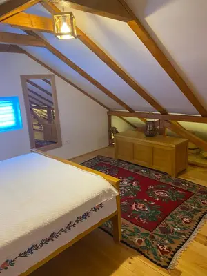 a bedroom with a bed and a dresser and a rug at Village house DUNJA in Virpazar