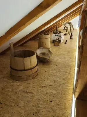 a room with two wooden barrels in a attic at Village house DUNJA in Virpazar