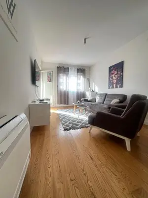 a living room with a couch and a table at White Homes 1BR - Central Point in Podgorica