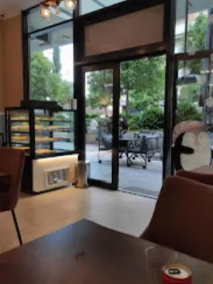 a living room with a large glass door to a patio at White Homes 1BR - Central Point in Podgorica