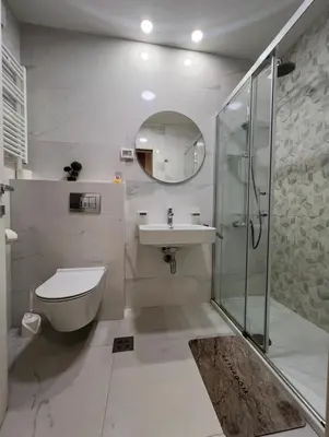 a bathroom with a toilet and a sink and a shower at White Homes 1BR - Central Point in Podgorica
