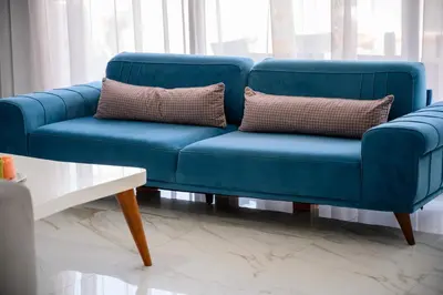 a blue couch with two pillows in a living room at Luxury Scandinavian - Villa Montenegro in Ulcinj