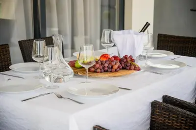 a white table with plates and glasses of wine at Luxury Scandinavian - Villa Montenegro in Ulcinj