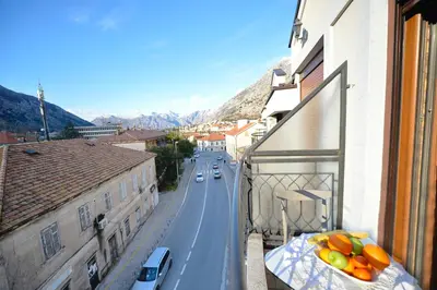 a view of a street from a balcony with fruit on a table at Stylish apartment 22 in Kotor