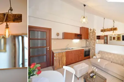 a kitchen and a living room with a couch at Stylish apartment 22 in Kotor