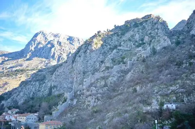 a large rocky mountain with houses on it at Stylish apartment 22 in Kotor