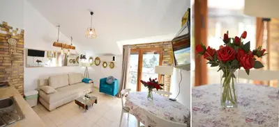 a living room with a couch and a table with red roses at Stylish apartment 22 in Kotor