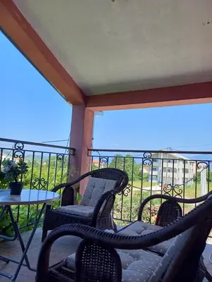 a patio with two chairs and a table on a balcony at Apartman Balsa in Kotor