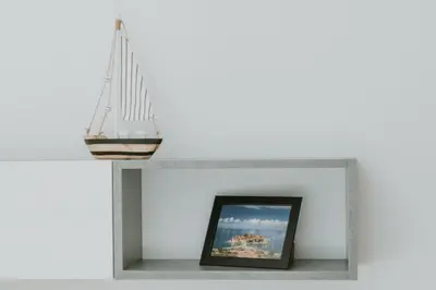 a shelf with a picture of a sail on top of a fireplace at Modern Spacious Fully Equipped One Bedroom Apartment in Budva, Free Parking, Ideal for Long Stays in Budva