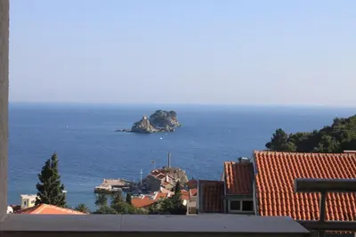 a view of a small island in the ocean at Petrovac Holiday apartments 1 in Petrovac na Moru