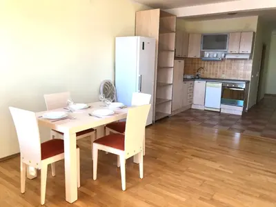 a kitchen with a table and chairs in a room at Petrovac Holiday Apartments 2 in Petrovac na Moru