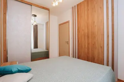 a bedroom with a bed and a large mirror at Status-M Apartments 134 in Becici